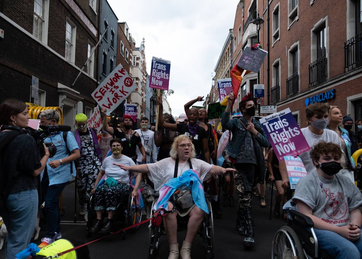 A group of people in wheelchairs on a street.