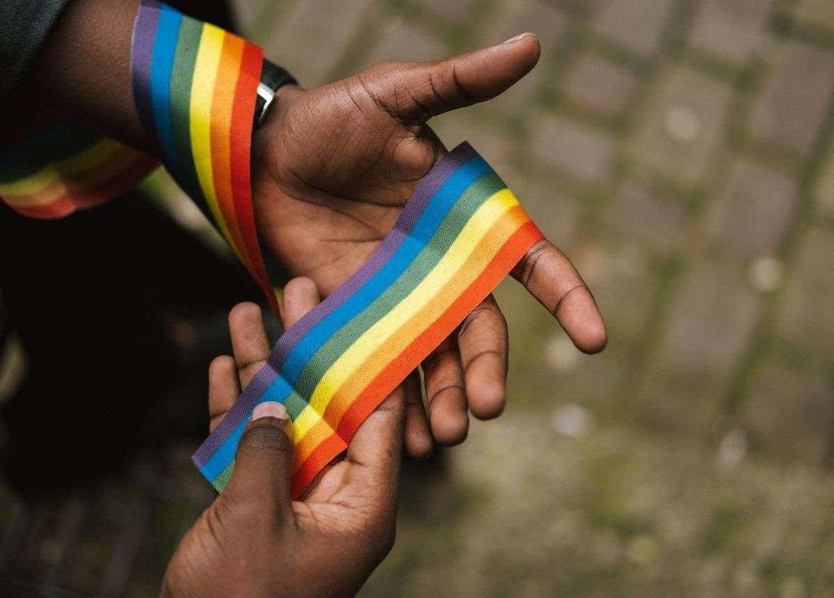 rainbow flag and black hands