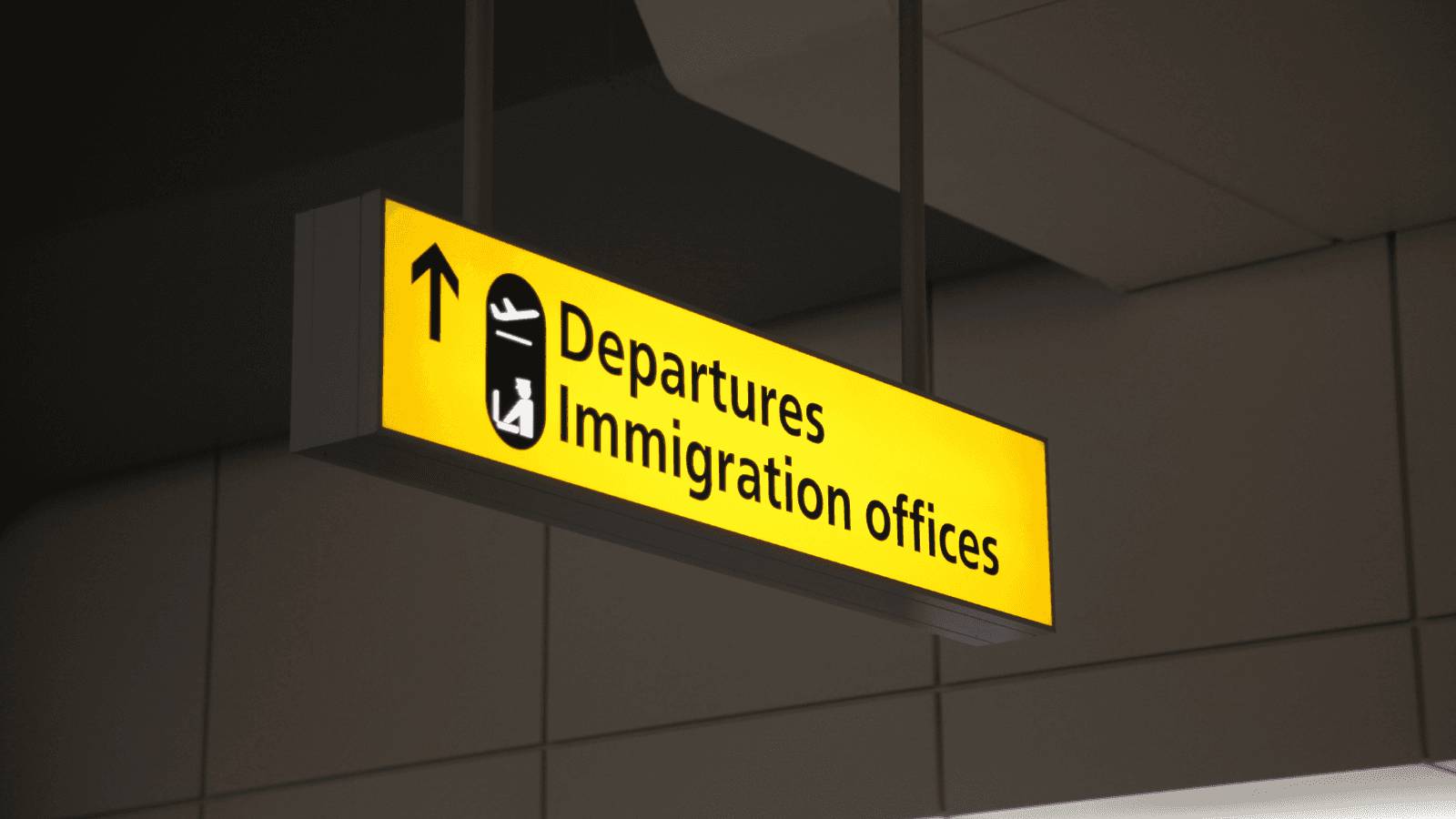 A sign that says departures immigration offices.